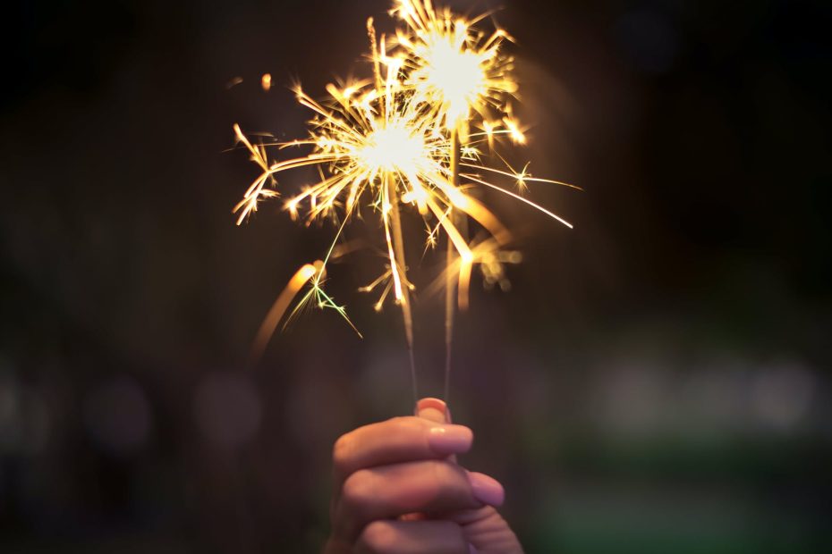 person holding lighted sparkler